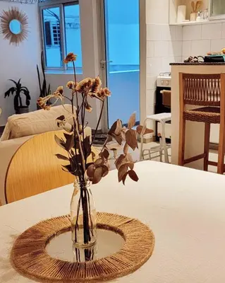 a vase with flowers in it sitting on a table at La mejor ubicación para alojarte! in Cordoba