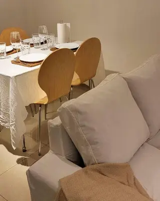 a table with a couch and chairs with wine glasses at La mejor ubicación para alojarte! in Cordoba