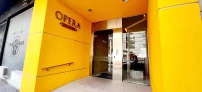 an entrance to a store with a yellow wall at Torre Opera Depto 3º B in Villa Carlos Paz
