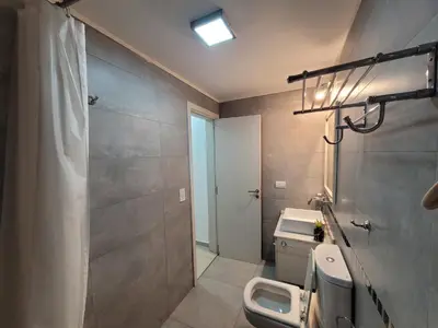 a bathroom with a sink and a toilet and a shower at Torre Opera Depto 3º B in Villa Carlos Paz