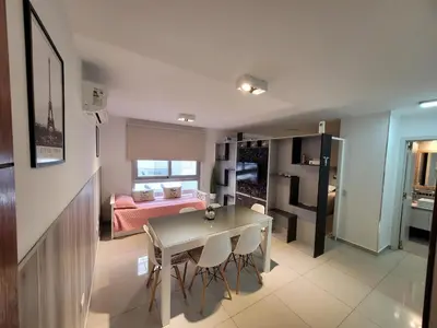 a living room with a table and a bedroom at Torre Opera Depto 3º B in Villa Carlos Paz