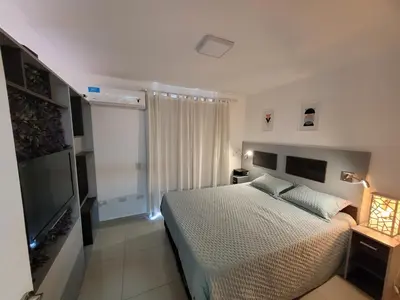 a bedroom with a bed and a flat screen tv at Torre Opera Depto 3º B in Villa Carlos Paz