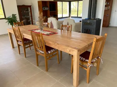 a wooden table and chairs in a living room at Casal Sur in Potrero de Garay