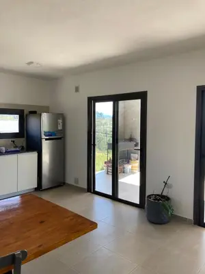 a living room with a door open to a patio at Casal Sur in Potrero de Garay