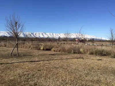 an empty field with a snow covered mountain in the background at Casonas de Nono in Nono