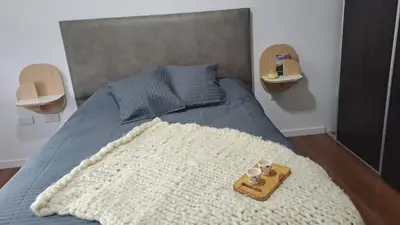 a bed with a tray and two cups on it at Alma Serrana VGB in Villa General Belgrano