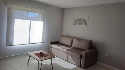 a living room with a couch and a table at Alma Serrana VGB in Villa General Belgrano