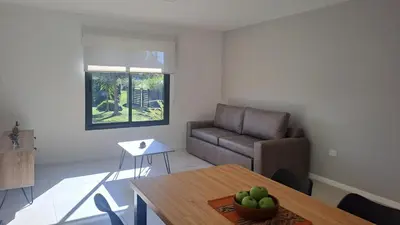 a living room with a couch and a table at Alma Serrana VGB in Villa General Belgrano