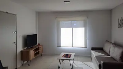 a living room with a couch and a tv at Alma Serrana VGB in Villa General Belgrano