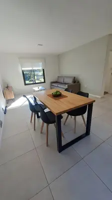 a dining room with a wooden table and chairs at Alma Serrana VGB in Villa General Belgrano