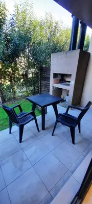 a picnic table and two chairs on a patio at Alma Serrana VGB in Villa General Belgrano
