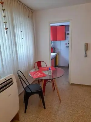 a room with a table and chairs and a kitchen at Mi lugar, tu lugar in Cordoba