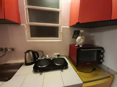 a kitchen with a stove and a microwave at Mi lugar, tu lugar in Cordoba