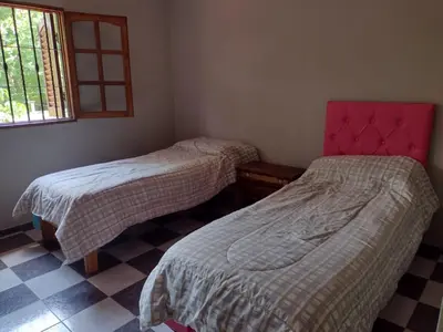 a room with two beds and a window at Complejo La Tere- depto 1 in Cordoba