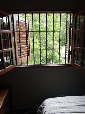 a bedroom with a large window with a bed in it at Complejo La Tere- depto 1 in Cordoba