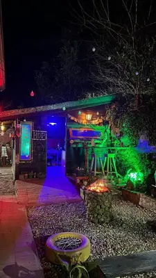 a building with green and purple lights on it at Hostel del pueblo in Amboy