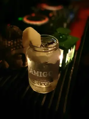 a glass jar with a candle on a table at Hostel del pueblo in Amboy