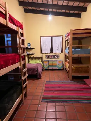 a room with several bunk beds in a room at Hostel del pueblo in Amboy