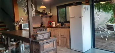 a kitchen with a white refrigerator and a stove at Vista Alago in Villa Ciudad Parque