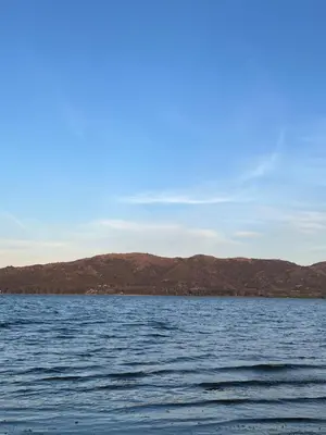 a large body of water with mountains in the background at Cabaña La Maura in La Estancia