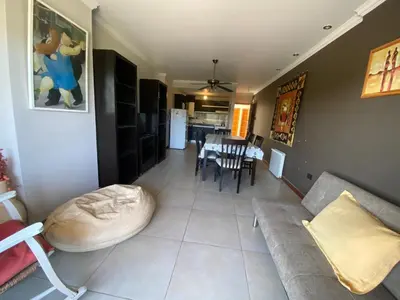 a living room with a couch and a table at Depto en pleno centro con pileta, cochera, hermosa vista in Villa Carlos Paz