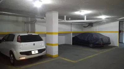 a parking garage with two cars parked in it at Depto en pleno centro con pileta, cochera, hermosa vista in Villa Carlos Paz