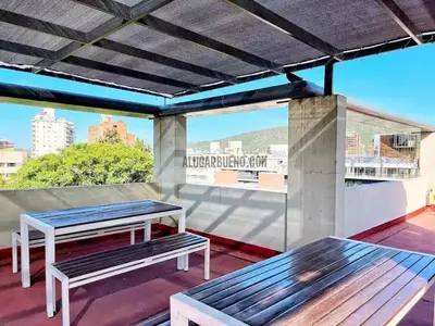 two benches sitting on top of a roof at Depto en pleno centro con pileta, cochera, hermosa vista in Villa Carlos Paz