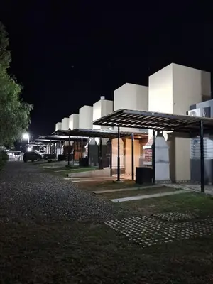 a lit up building with a parking lot at night at El 8 del mirador in Villa Santa Cruz del Lago
