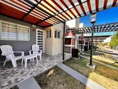 a patio with two chairs and a table and a grill at El 8 del mirador in Villa Santa Cruz del Lago