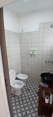 a bathroom with a toilet and a sink at Tempo Suites in Cordoba