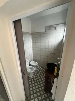 a bathroom with a toilet and a sink at Tempo Suites in Cordoba