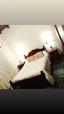 a bedroom with a bed with white sheets and pillows at Cabaña Los Espinillos in Cortaderas