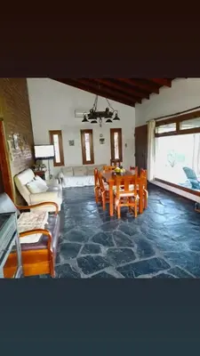 a living room with a table and chairs at Cabaña Los Espinillos in Cortaderas