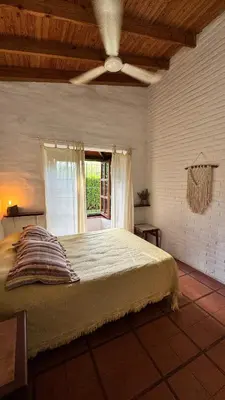 a bedroom with a large bed and a window at Casita Lavanda - cercana a plaza de Villa de las Rosas con patio y asador in Villa de Las Rosas