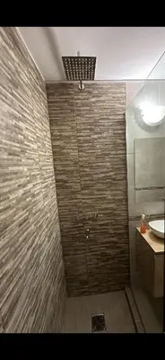 a bathroom with a shower and a sink at Paseo del Boulevard Suite in Cordoba