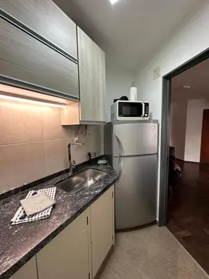 a kitchen with a sink and a stainless steel refrigerator at Paseo del Boulevard Suite in Cordoba