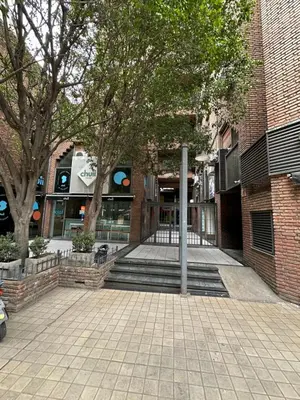 a brick building with stairs and trees in front of it at Paseo del Boulevard Suite in Cordoba