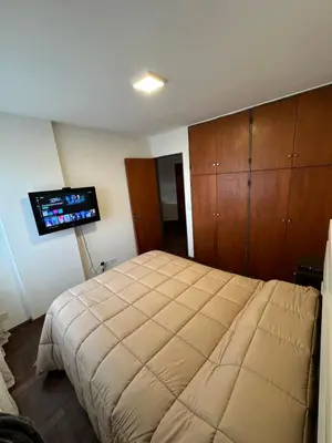 a bedroom with a bed and a flat screen tv at Paseo del Boulevard Suite in Cordoba