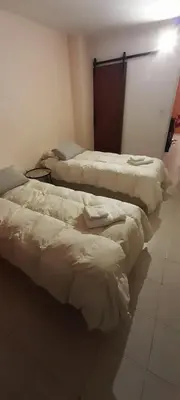 three beds are lined up in a room at Hermoso Dpto con Cochera en Nueva Cba!!!! in Cordoba