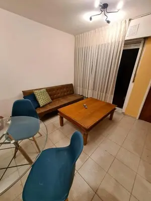 a living room with a couch and a table and chairs at Hermoso Dpto con Cochera en Nueva Cba!!!! in Cordoba