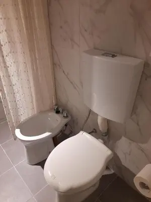 a bathroom with a white toilet and a sink at Hermoso Dpto con Cochera en Nueva Cba!!!! in Cordoba