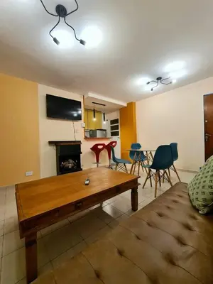 a living room with a couch and a table and chairs at Hermoso Dpto con Cochera en Nueva Cba!!!! in Cordoba