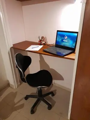 a desk with a laptop computer on top of it at Hermoso Dpto con Cochera en Nueva Cba!!!! in Cordoba