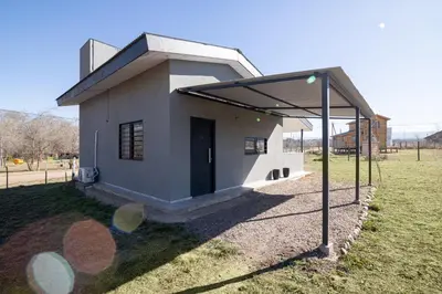 a small building with a roof on a field at La Floridita in Villa Ciudad Parque