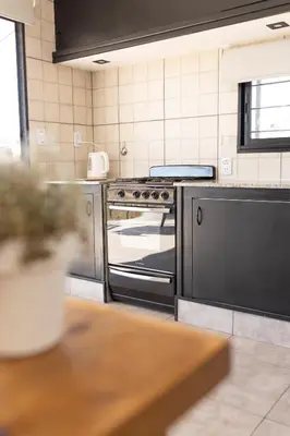 a kitchen with a stainless steel oven in a kitchen at La Floridita in Villa Ciudad Parque