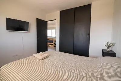 a bedroom with a bed and a flat screen tv at La Floridita in Villa Ciudad Parque