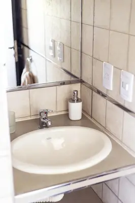 a bathroom with a sink and a mirror at La Floridita in Villa Ciudad Parque