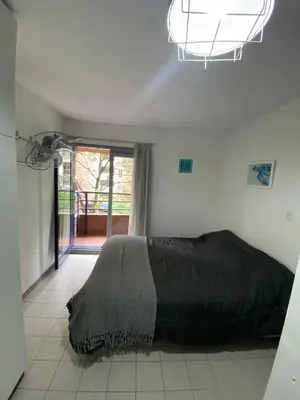 a bedroom with a bed in a room with a window at Monoambiente en Nueva Córdoba in Cordoba