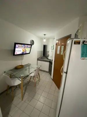 a kitchen with a glass table and a refrigerator at Monoambiente en Nueva Córdoba in Cordoba