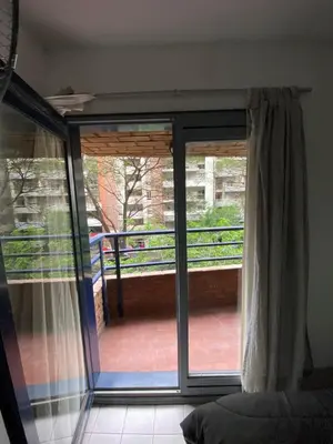 a sliding glass door with a view of a balcony at Monoambiente en Nueva Córdoba in Cordoba